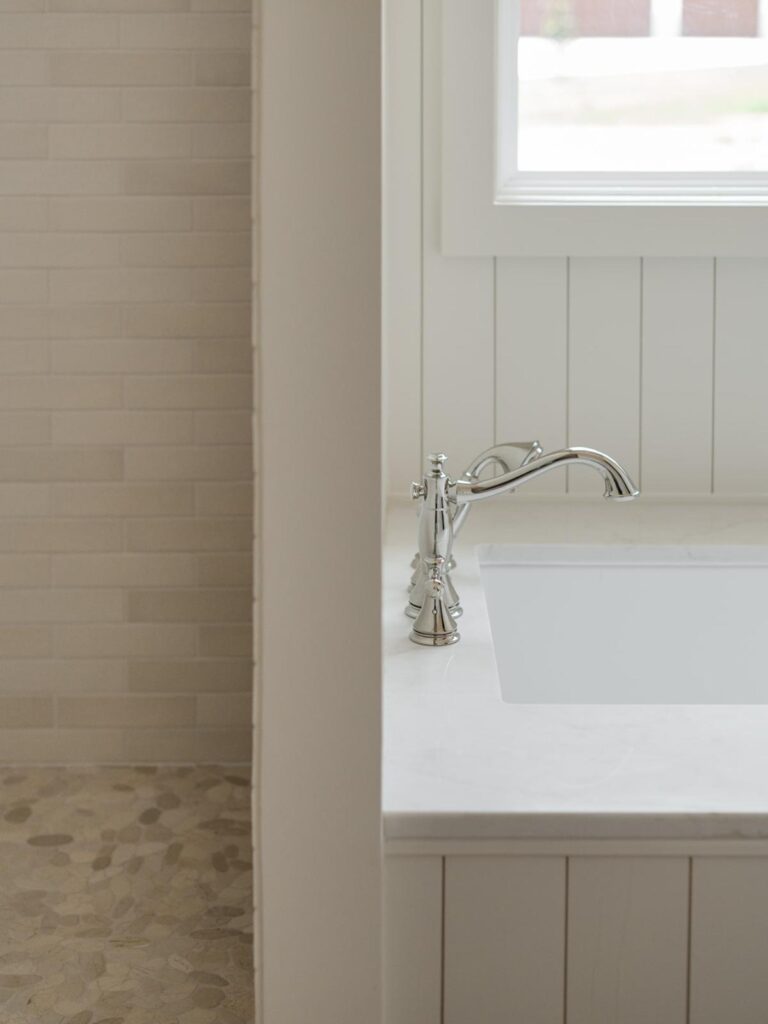 master bathroom with drop-in tub and shiplap walls 